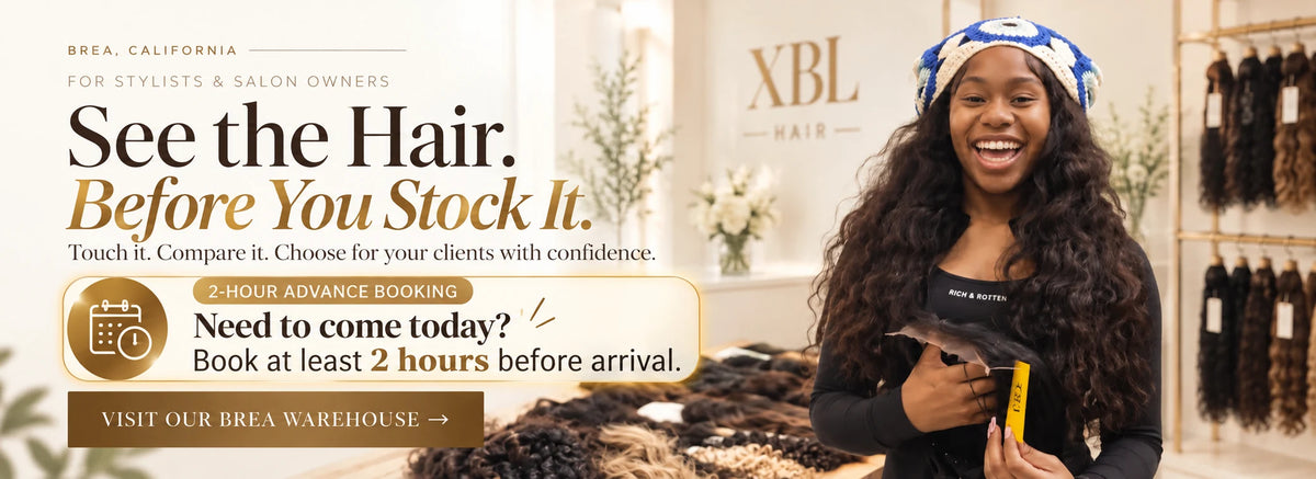 A smiling woman with long, wavy black hair stands in a salon interior holding a hair extension sample. The scene includes salon branding text, shelves of hair pieces, and promotional copy about seeing the hair before you stock it.
