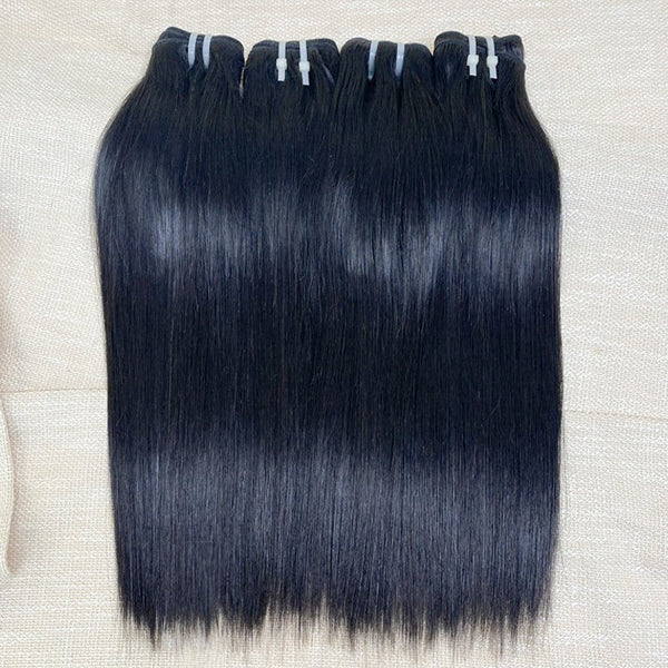 Three bundles of straight black human hair extensions laid out on a surface.