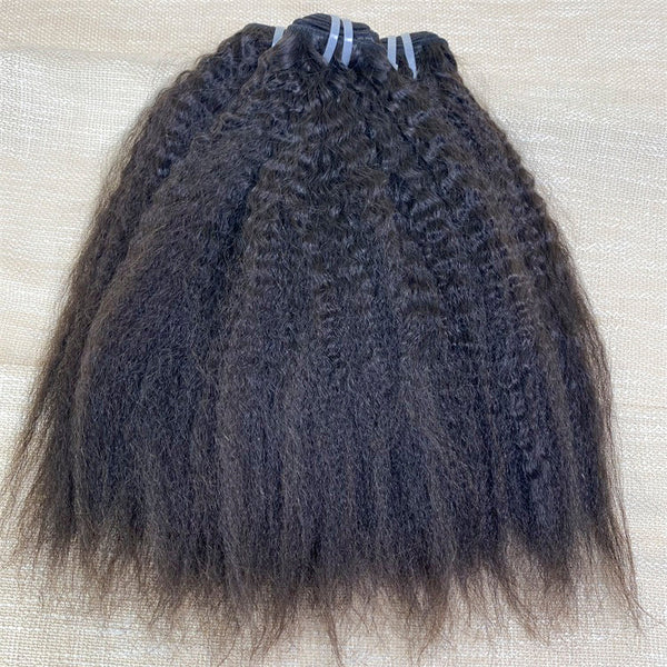 A bundle of kinky straight, black Vietnam human hair extensions laid out on a surface.